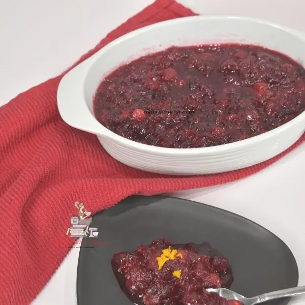Instant Pot cranberry sauce in a white dish and on a grey plate.