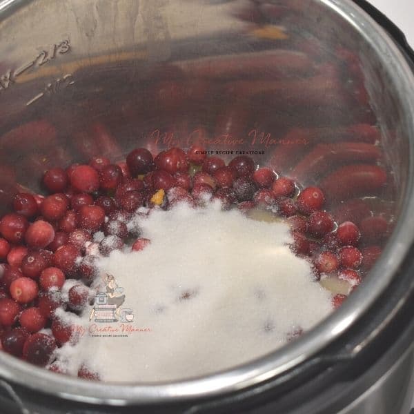 Fresh cranberries with sugar on them in an inner pot.