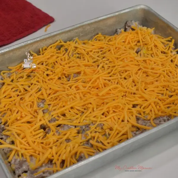 Cheese topping other ingredients in a baking dish.