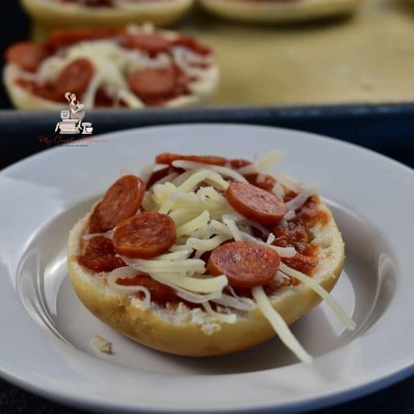 Pepperoni, cheese, and pizza sauce on a mini bagel.