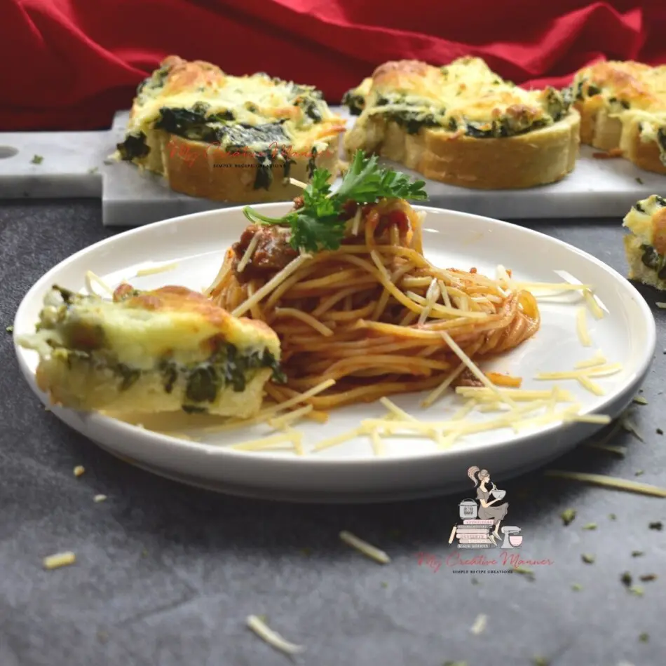 A pasta recipe that is on a white plate with a garlic cheese toast.