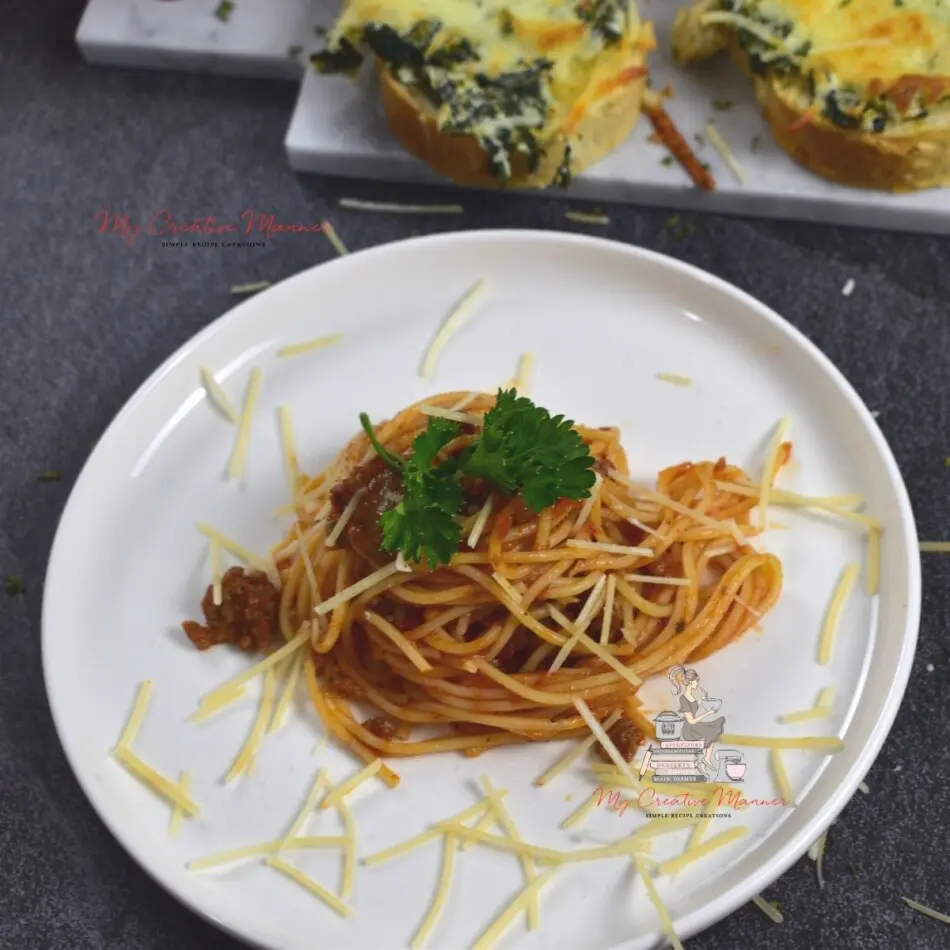Spaghetti with meat sauce on a white plate.
