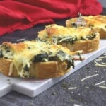 Spinach Artichoke Garlic Bread on a marble platter