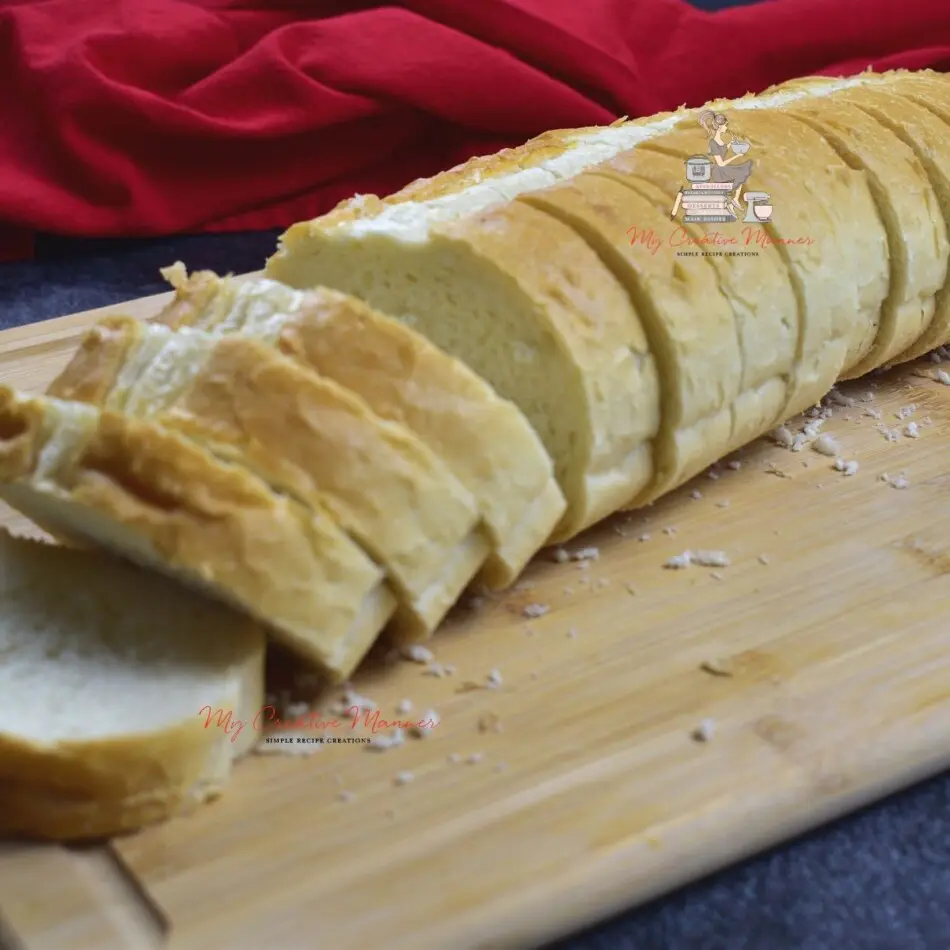 french bread that has been sliced on a cutting board.