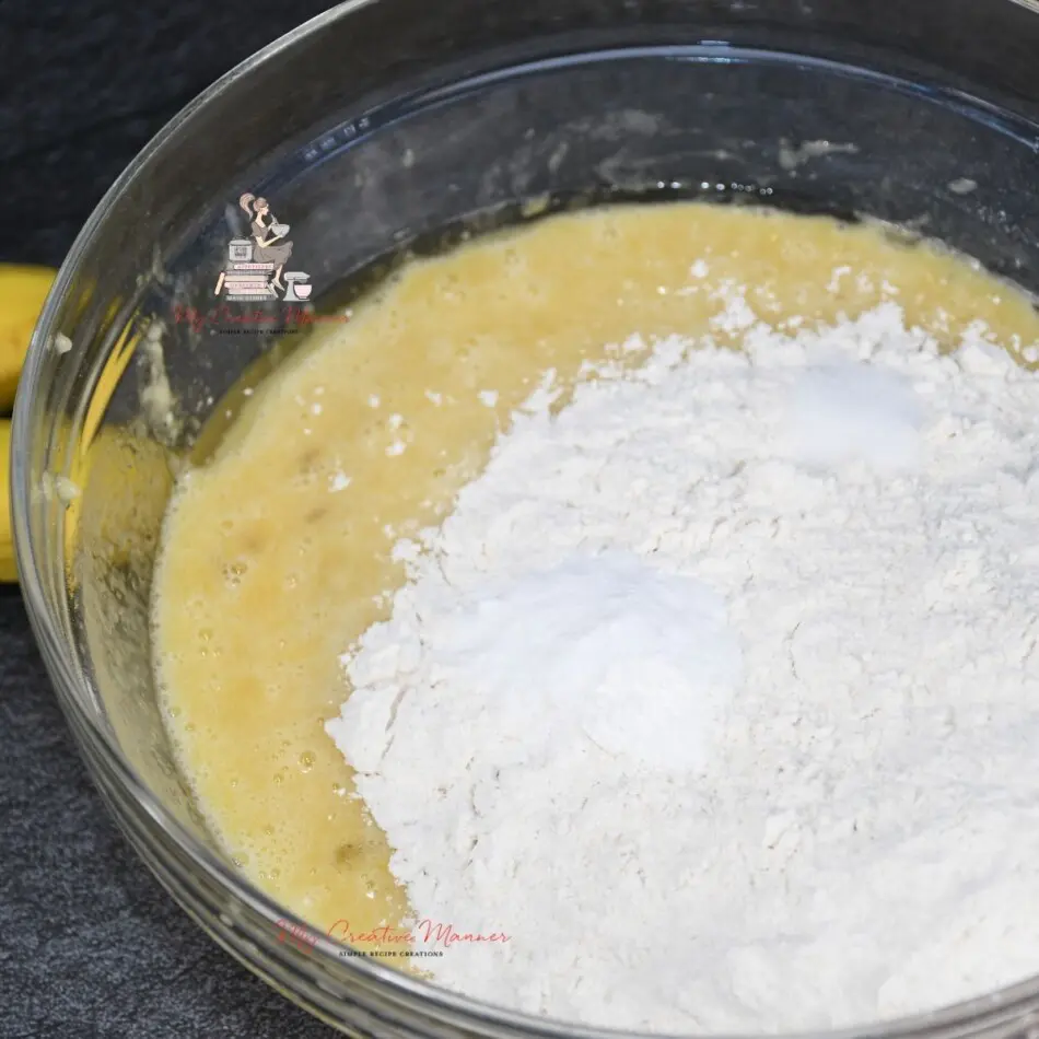 Flour being added into a muffin batter.