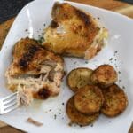One pan chicken and potatoes on a plate with a fork.