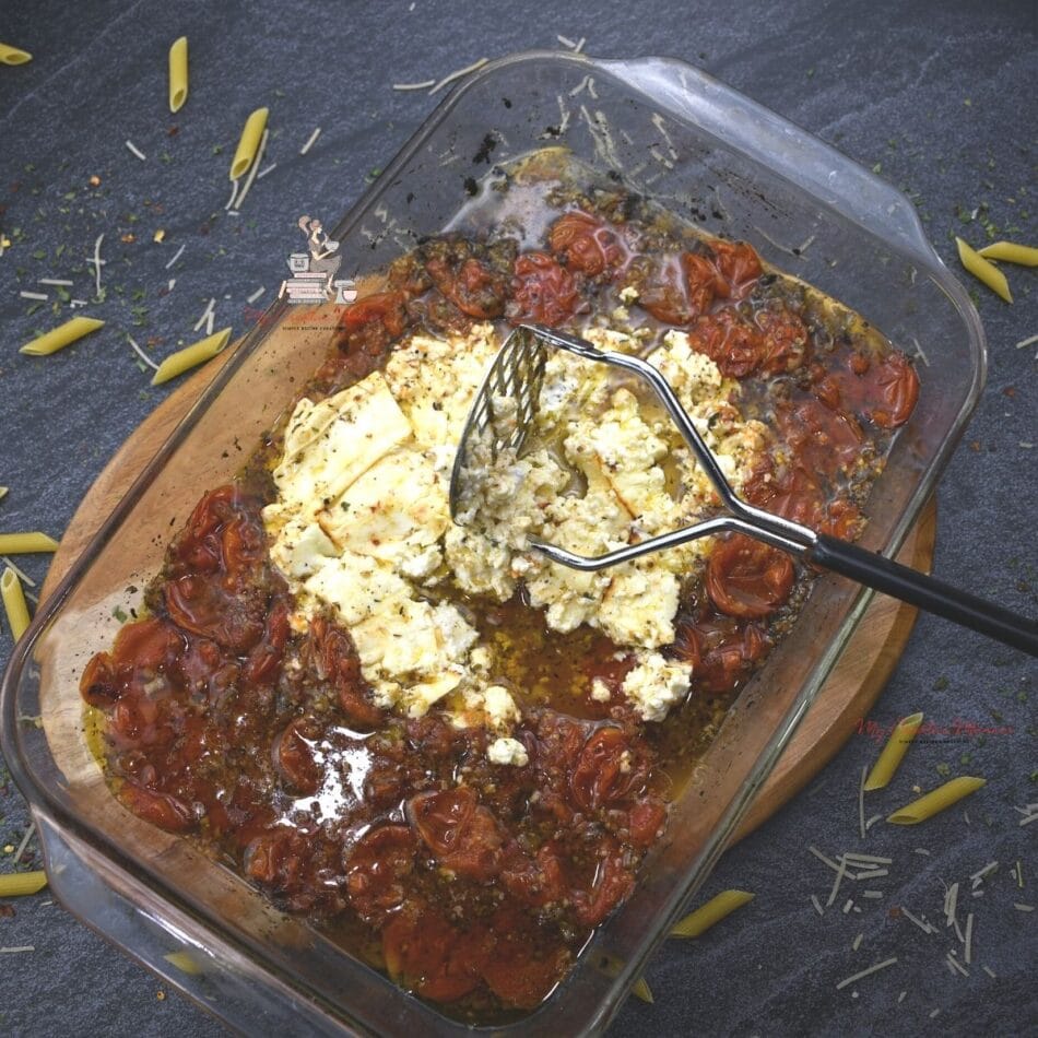 Oven roasted tomatoes and feta cheese in a baking dish.