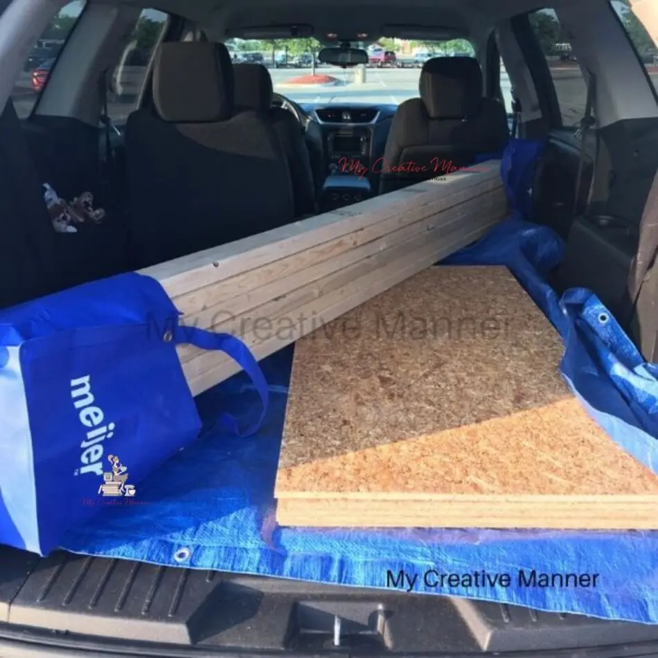 The wood to build a snow village platform in the back of a car.