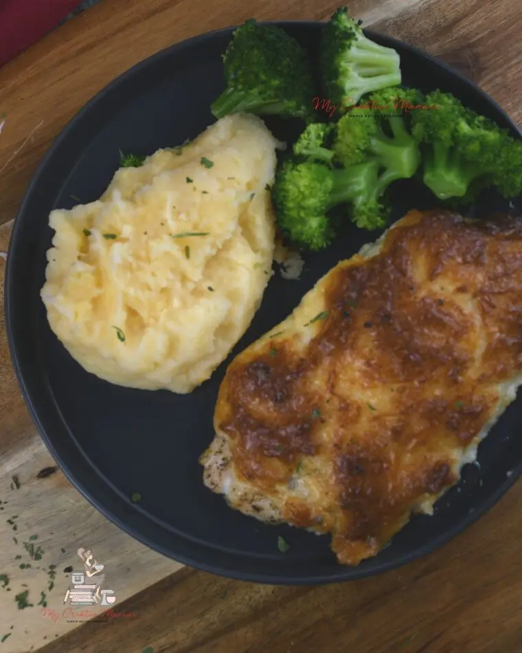 Mayo chicken parmesan  along with potatoes and broccoli on a plate.