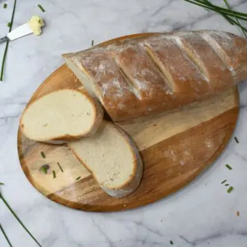 French Bread that has been sliced on a cutting board.