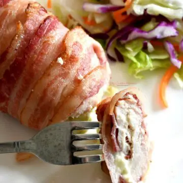 A slice of jalapeno popper chicken on a fork.