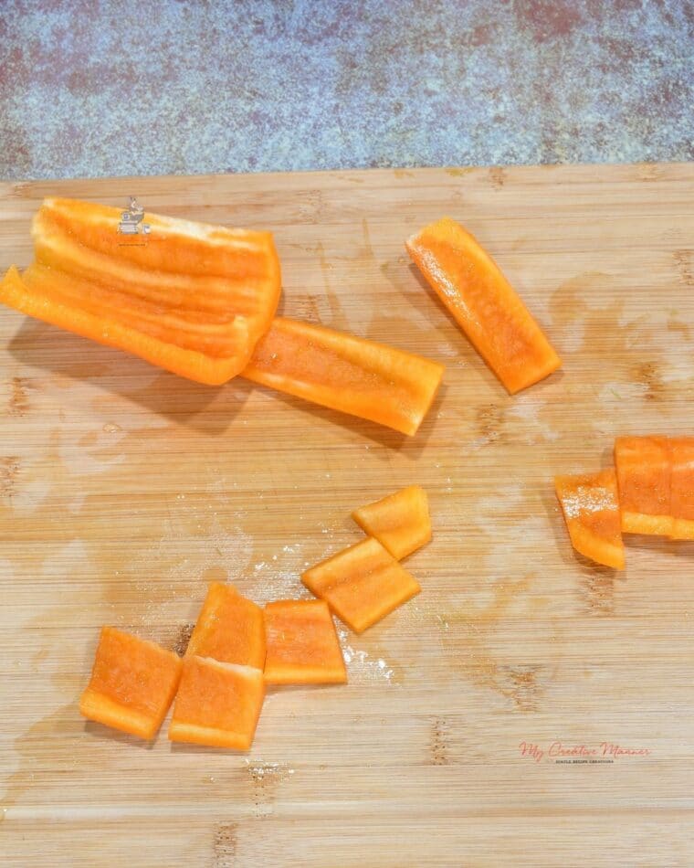 An orange bell pepper that is cut up.