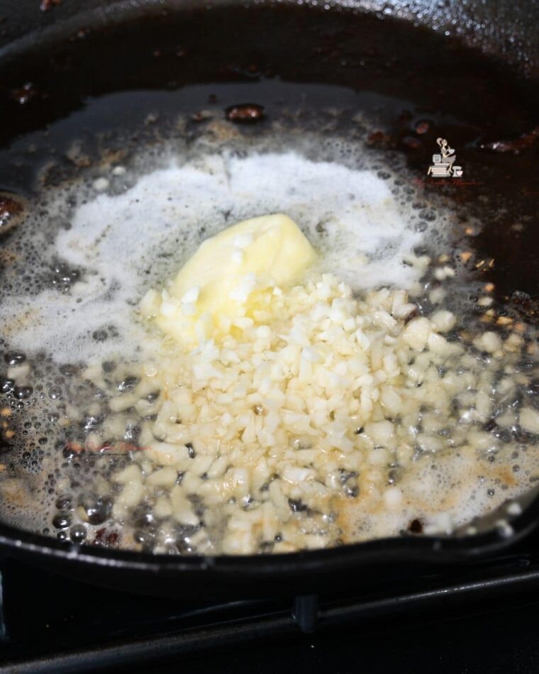 Garlic in a cast iron pan with butter.