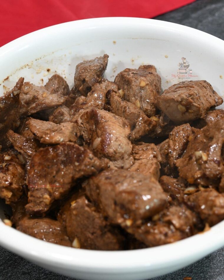 A white bowl filled with sirloin tips.