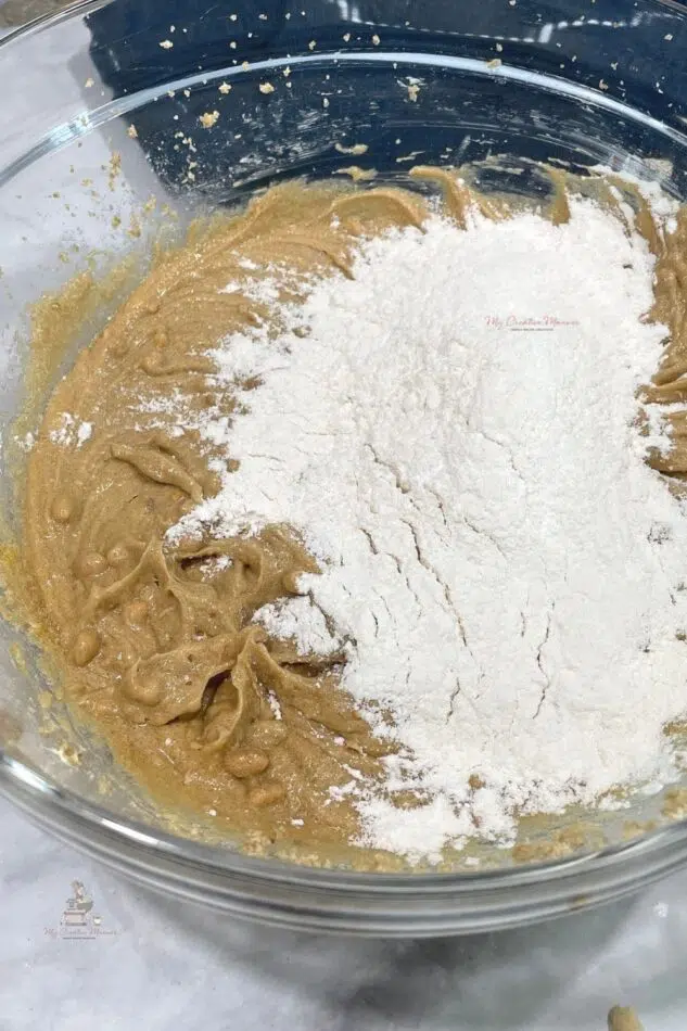 Creamed butter and sugar with flour being added into it.