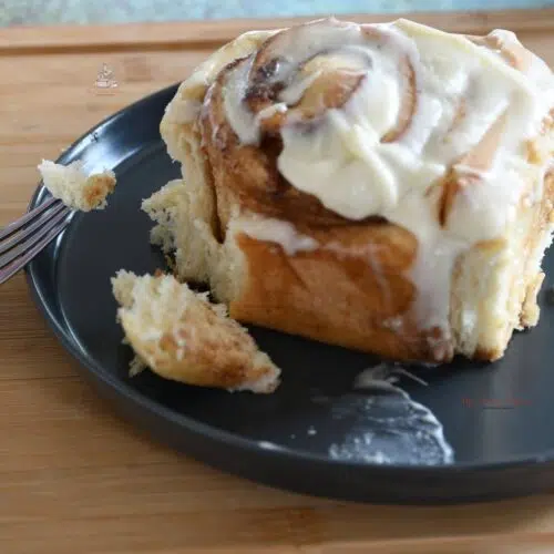Mouth watering homemade cinnamon roll with cream cheese icing.