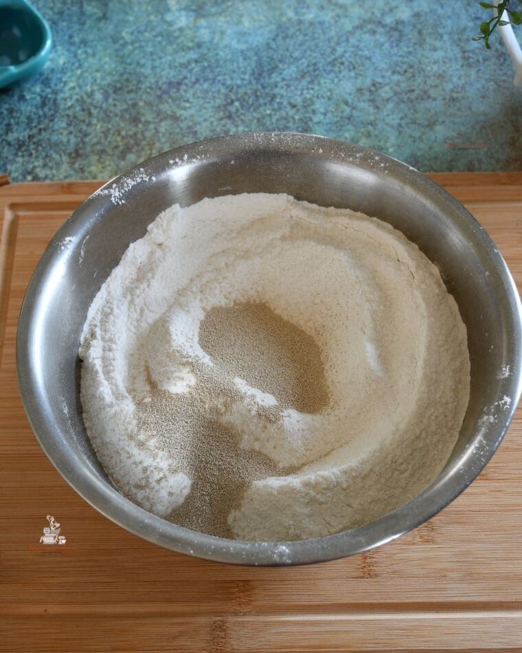 A bowl filled with flour and yeast.