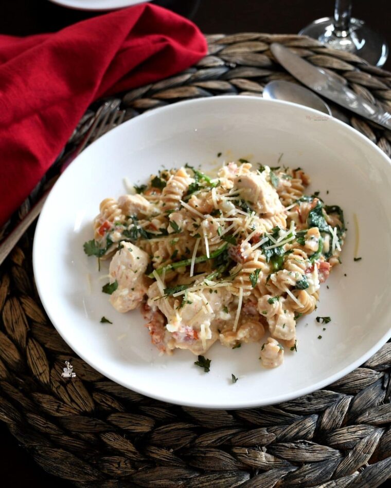 Healthy chicken recipe pasta on a white plate.