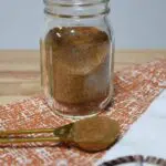 A mini mason jar that has the homemade pumpkin pie spice in it.