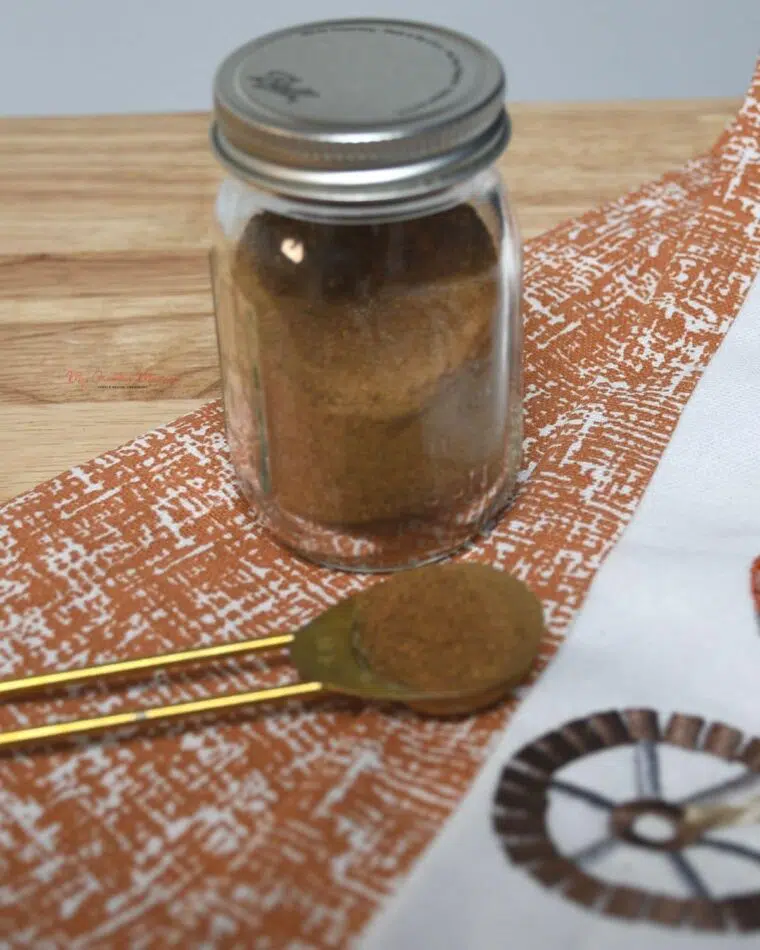 A mini mason jar that is filled with homemade pumpkin spice seasoning.