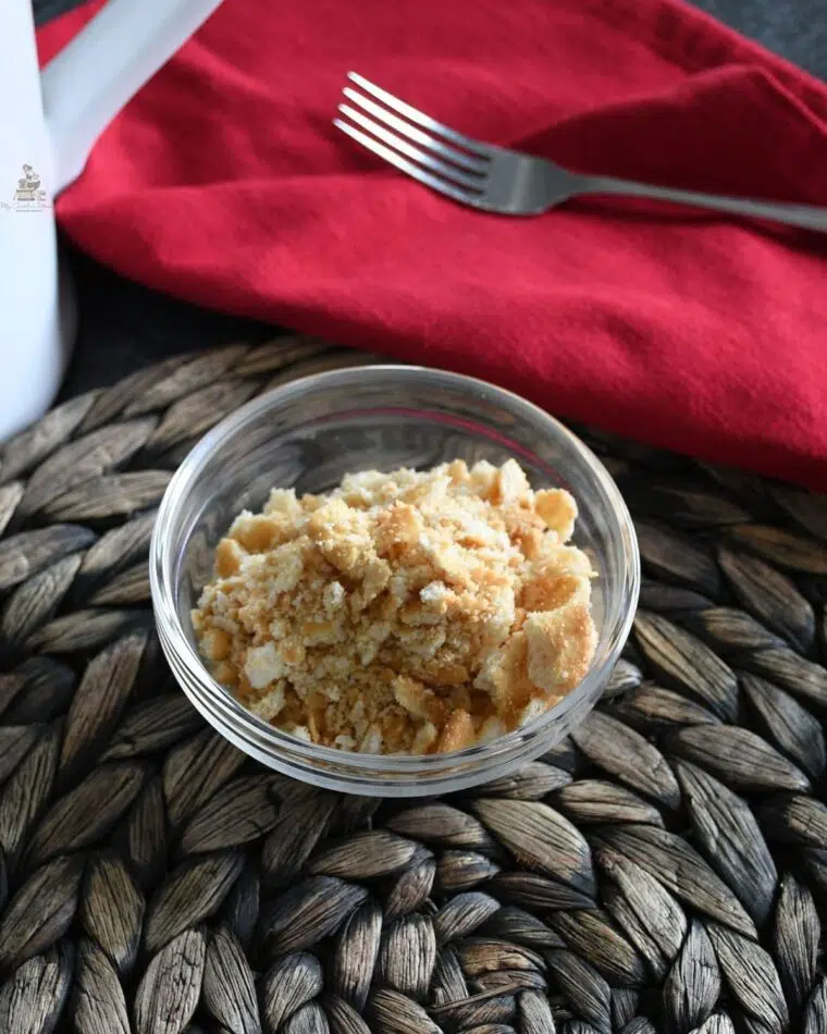 Crumbled up Ritz crackers in a bowl.