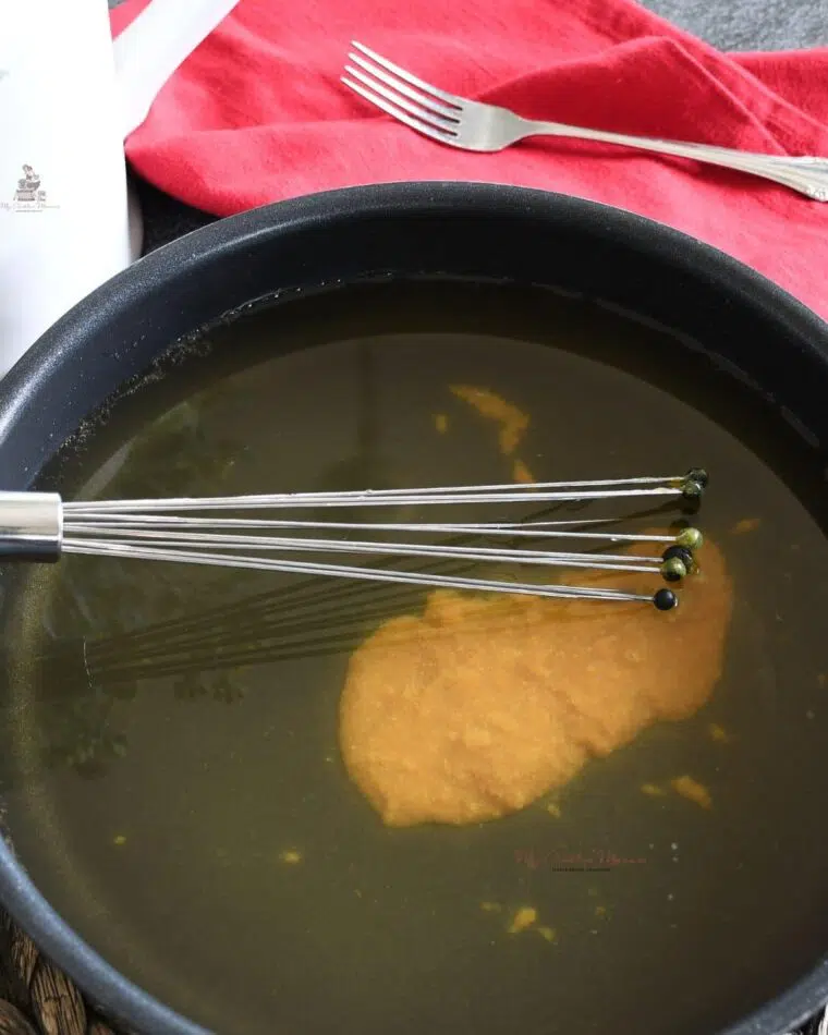 Chicken broth and better than bouillon in a large skillet with a whisk.This is the sauce for Frankenmuth buttered noodles recipe.