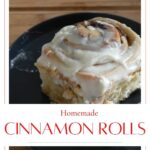 Tasty homemade cinnamon rolls with cream cheese icing on a grey plate.