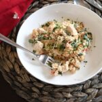Tuscan chicken pasta in a white bowl.