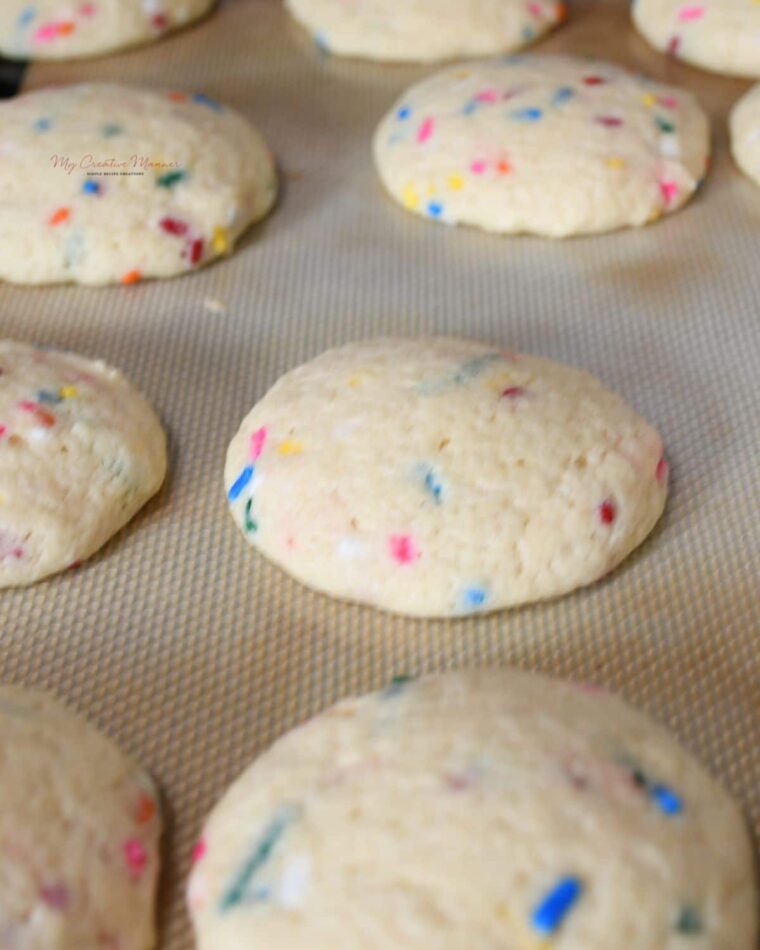 Funfetti cookies on a baking sheet pan.