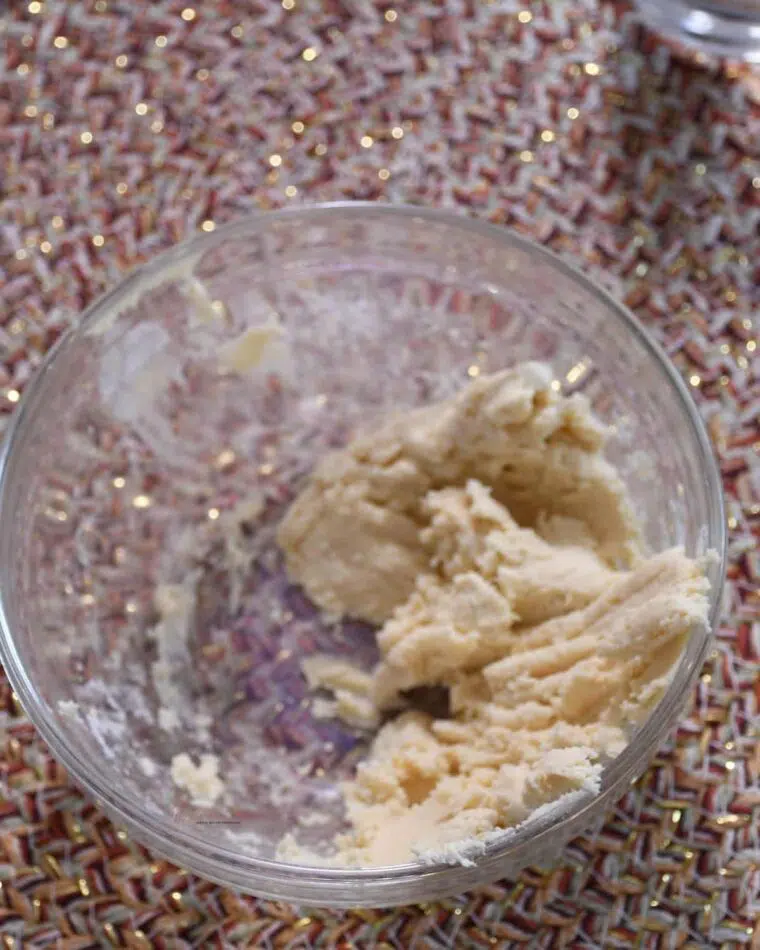 A bowl with butter and flour mixed together.