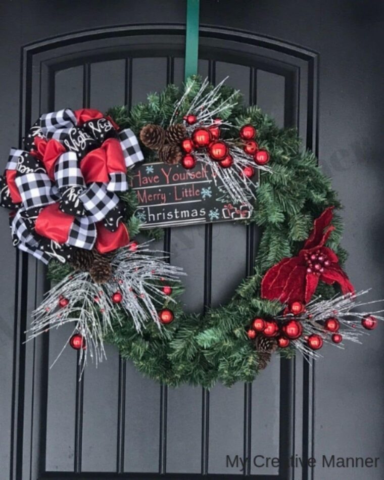 A Christmas wreath on a black from door. 