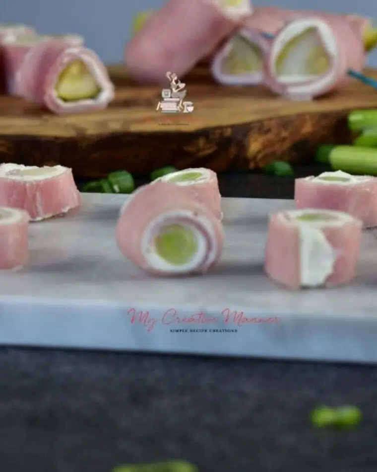 Ham and cream cheese roll ups that have pickles and green onions.