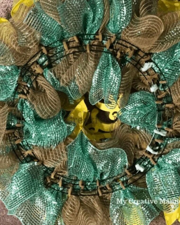 The backside of a mesh wreath on a wire frame.
