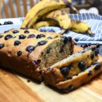 A loaf of banana blueberry bread that is sliced.