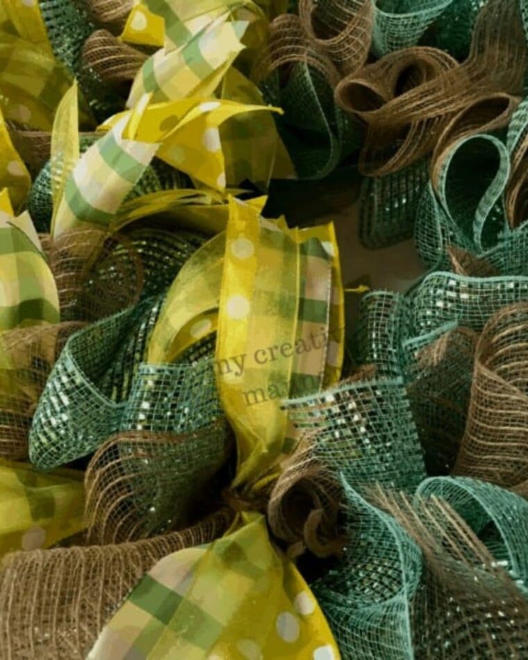 A close up of a mesh wreath with ribbon.