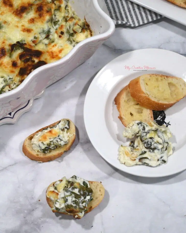 A baking dish with the baked spinach artichoke dip recipe in it.