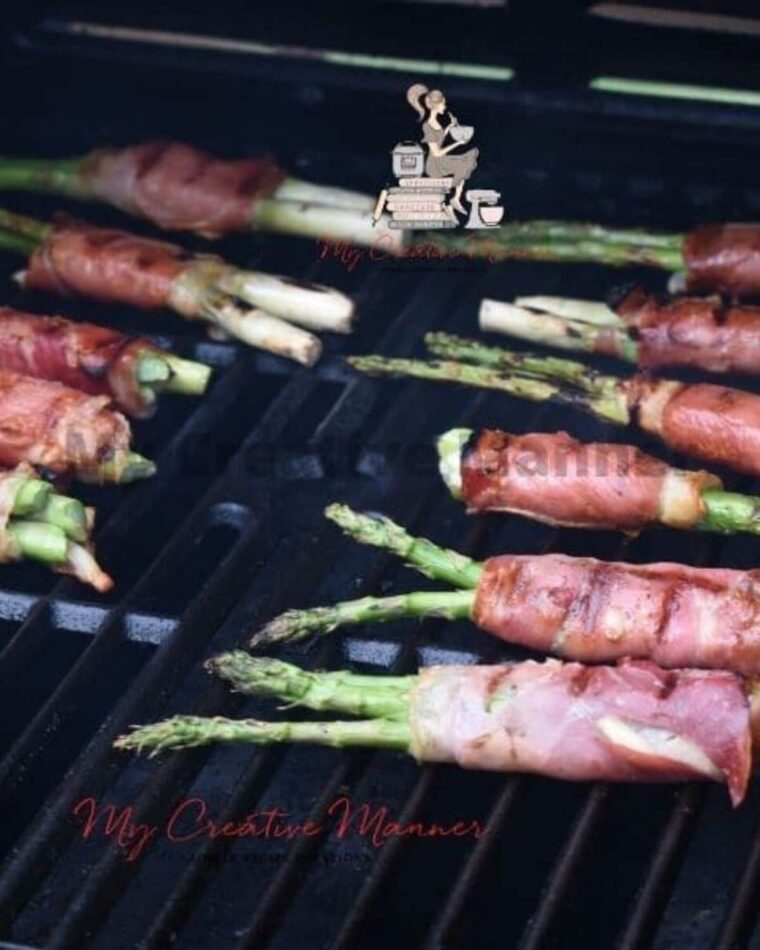 Grilled prosciutto wrapped asparagus being cooked.