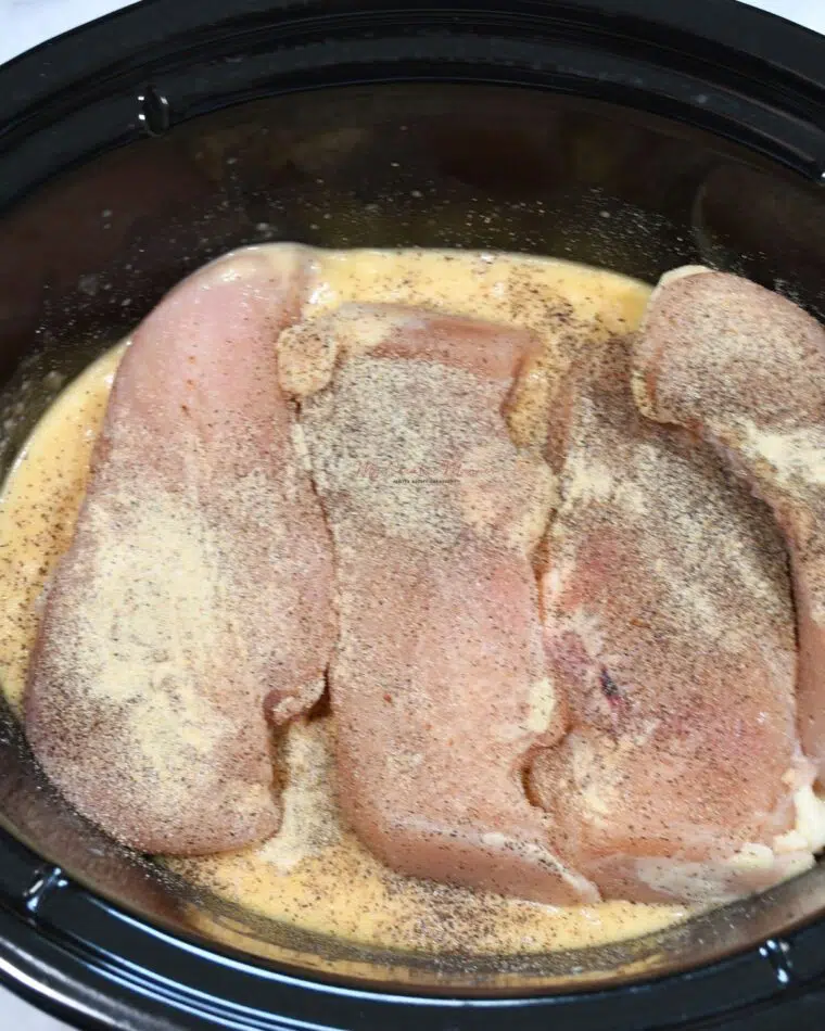 The ingredients for chicken and gravy in a crockpot.