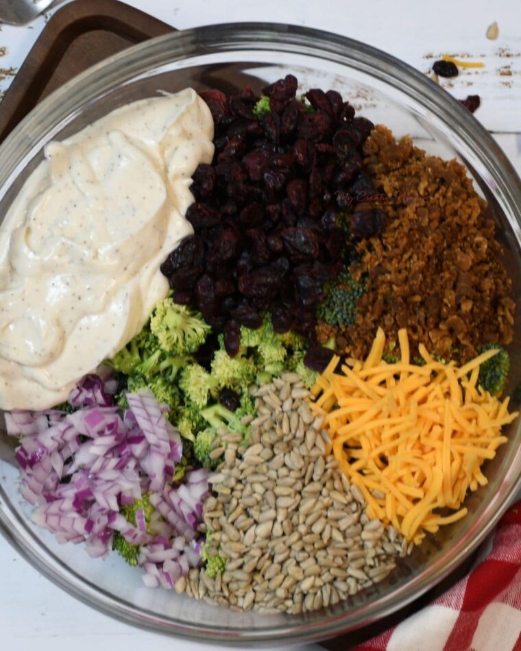 An overhead shot of a bowl filled with the ingredients for broccoli salad.