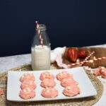 A plate that has strawberry cookies that was made with a cake mix on it.
