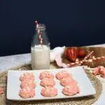 A plate that has strawberry cookies that was made with a cake mix on it.