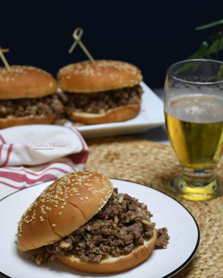 Gumbo burgers on a long plate with one burger closer.