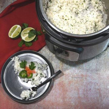 Overhead shot of an Instant Pot and a plate that has cilantro lime jasmine rice on it.