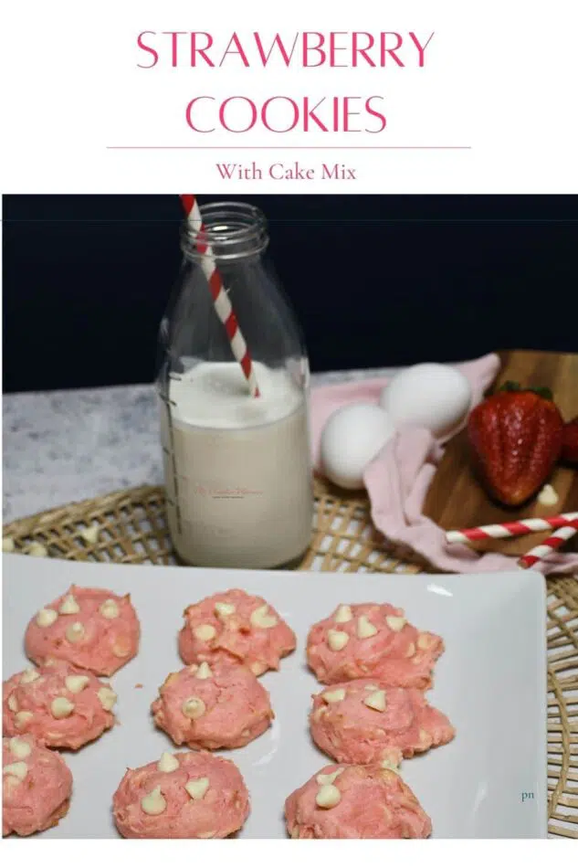A platter with strawberry cookies with white chocolate chips that are made from a cake mix. A glass of milk sits next to the platter.