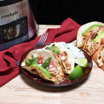 A plate that has rice and chicken tacos that was made in the crock pot on it.