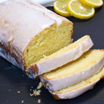 A close up of lemon bread with glaze that has been sliced.