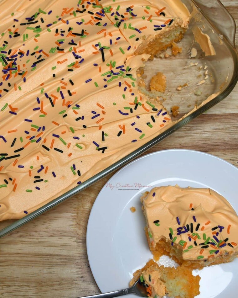 Overhead image of Halloween poke cake with a slice on a plate.