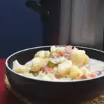 A close up image of a bowl filled with crockpot potato and ham soup.