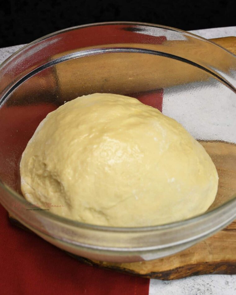 A bowl with dough to make cinnamon rolls with.