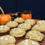 A close up of white chocolate pumpkin cookies.